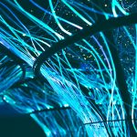 Fibras ópticas azuis luminosas formando um padrão abstrato e futurista.
